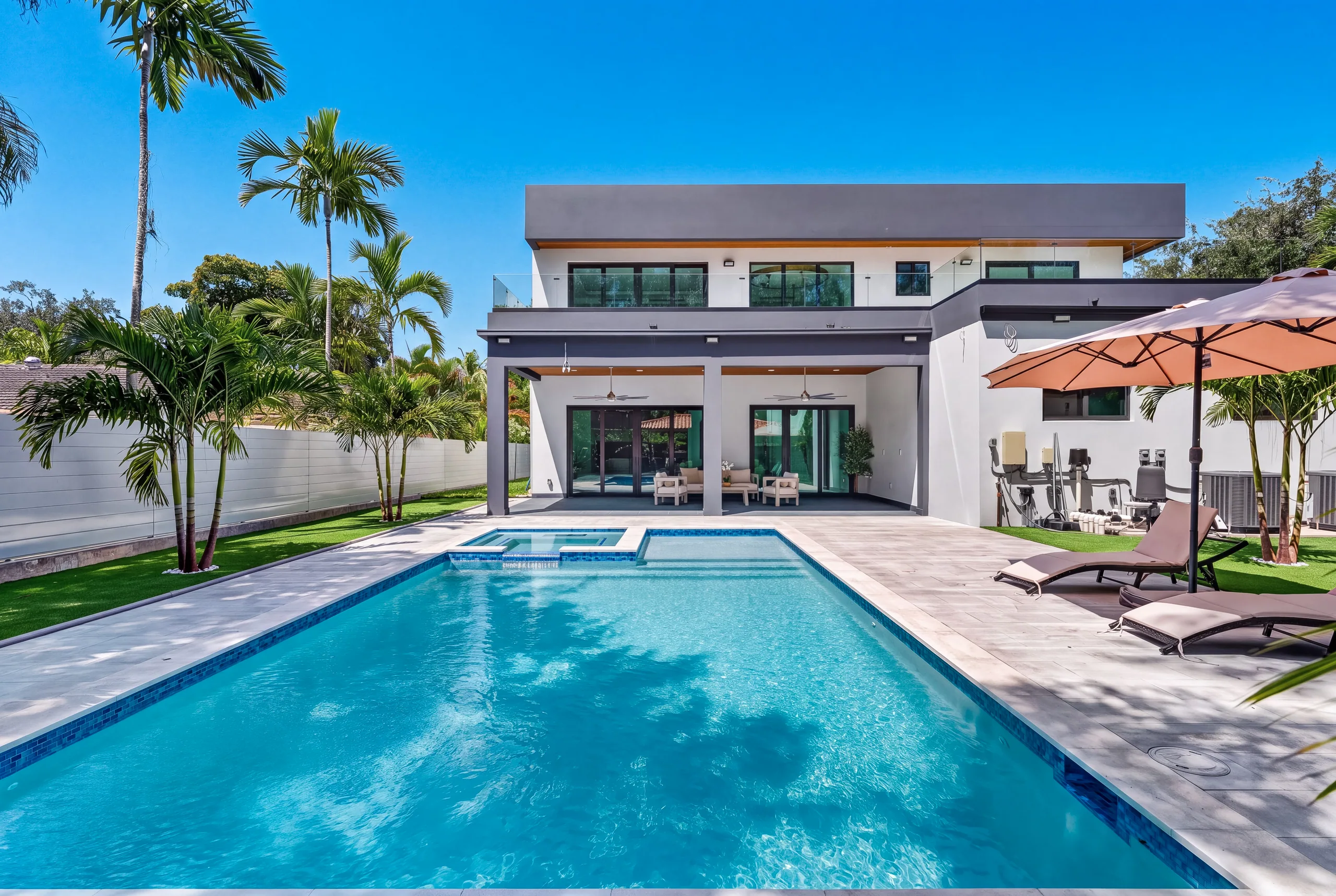 Sunlit residence overlooking a long swimming pool